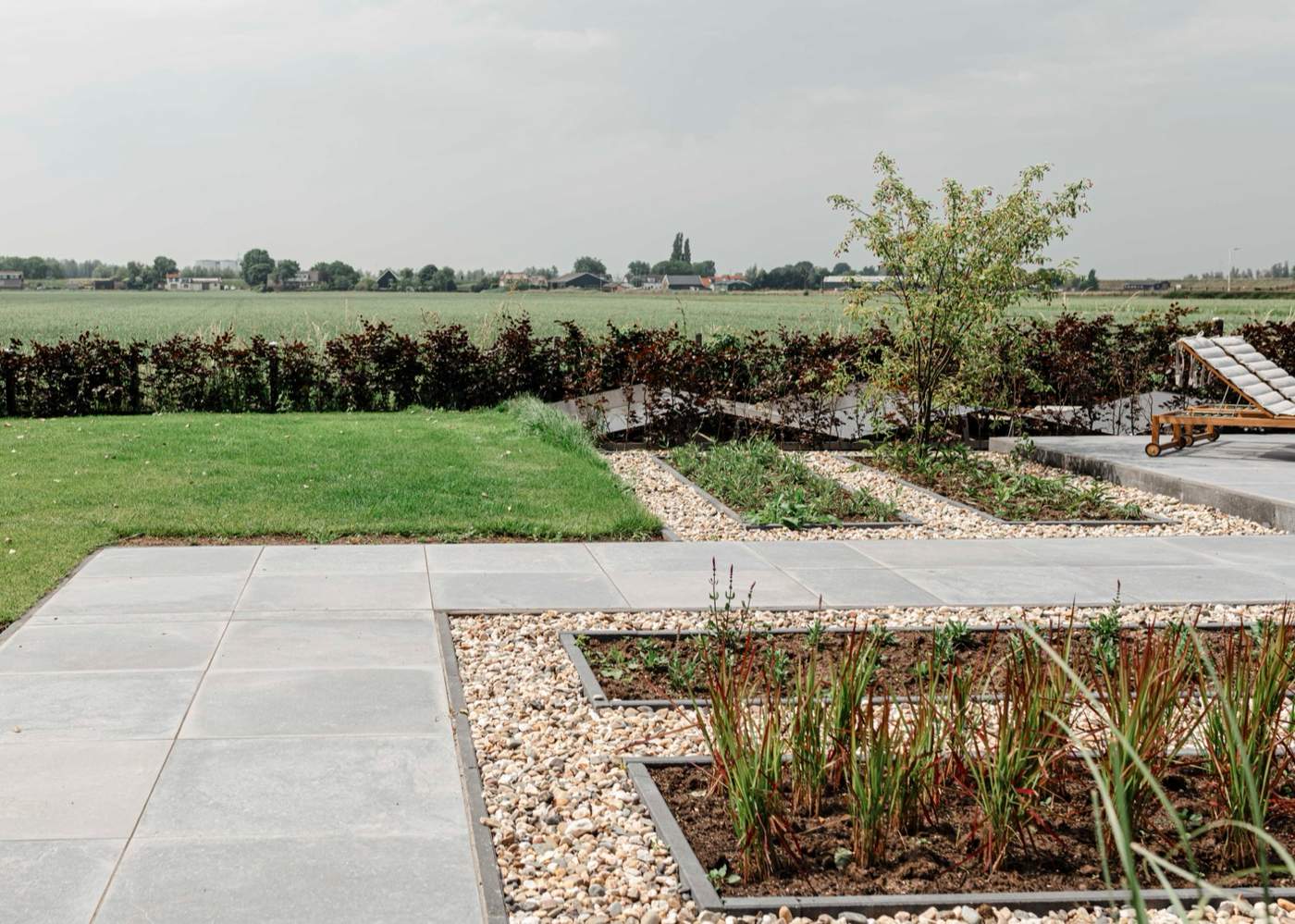 Landelijke tuin met grindoprit, bloeiende borders en volwassen bomen  Van der Lee Hovenier